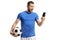 Surprised soccer player holding a ball and looking at a mobile phone