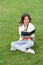 surprised teen child read book sitting on grass. reading book. reader girl with book outdoor