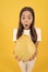 surprised teen girl hold fruit of yellow pomelo full of vitamin, selective focus, big fruit.