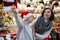 Surprised tween boy with mother at Christmas street market
