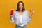 Surprised Woman Eating Burger And French Fries, Studio Shot