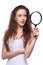 Surprised woman looking through magnifying glass