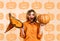 Surprised woman with pumpkin. Beautiful girl with jack-o-lantern and witch hat. Halloween background.