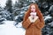 Surprised woman winter outdoor portrait, snowy fir trees background