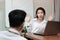 Surprised young Asian woman excited to get a white rose in office on valentine`s day. Love and romance in workplace concept.