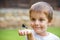 Surprised Young Boy and Dragonfly on his arm