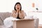 Surprised young lady unpacking wrong parcel, delivery mistake