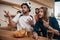 surprised young man in soccer ball hat gesturing and his friend sitting at bar with beer and chips during watch of football