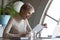 Surprised young short haired businesswoman reading paper documents.