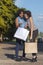 Surprised young woman checking purchases inside shopping bag