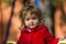 Surprising little girl dressing in red coat