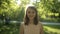 Surprisingly beautiful woman in a light blouse on background of summer park