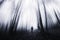 Surreal dark forest with fog and ghost walking through trees