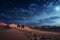 Surreal desert landscape under a starry sky, with towering sand dunes stretching into the distance. Generative AI