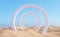 Surreal desert landscape with white arch constructions in perspective