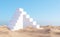 Surreal desert landscape with white staircases on sand