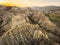 Surreal dramatic deserted earth landscape panorama with beautiful cliff formations and golden sunset background in Vashlovani