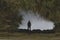 A surreal, haunted landscape upside down, with a figure reflected standing by water