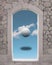 Surreal historical archways made with stone with unusual landscape, white sphere in a cloudy sky