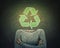 Surreal image young woman crossed hands and recycle symbol instead of head drawn over blackboard background. Ecology and greening