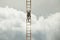 Surreal man tries to reach the sky with a ladder fearfully looking down, the concept is business and success