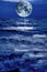 Surreal moon hovering above blue stormy water