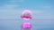 Surreal ocean landscape with pink circle and cloud in the blue sky over the sea waters. Modern minimal abstract