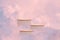 Surreal podium outdoor on blue sky pink violet pastel soft clouds with space.Beauty cosmetic product placement pedestal present