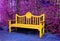 Surreal Pop Art Style Yellow Wooden Bench in Purple Colored Garden