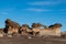 Surreal sculpted rock formation with natural window under a blue sky