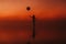 surreal silhouette of a girl with a balloon in her hand on the water