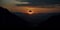 Surreal solar eclipse at sunset over mountains. Mystical eclipse illustration over a desert mountain range.