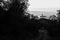 Surreal and uncommon view of St.Francis church in Assisi town Umbria over a sea of fog, at the end of a road in the