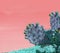 Surrealistic abstract blue thorny cactus against pink orange sky