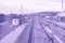 Surrealistic violet toned perspective image of the large railway