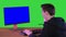 Surveillance agent and hacker answering a phone call on a Green Screen, Chroma Key.