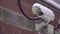 Surveillance and security CCTV camera on a city building wall, security system.