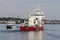 Survey vessel Geosea looming over high-speed ferry Nantucket Express