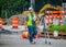 Surveyer calling out to someone on construction site with book in his hand by tripod with Optical Leve