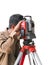 Surveying measuring equipment level theodolite on tripod at cons