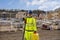 Surveyor builder site engineer with theodolite total station at construction site outdoors during surveying work