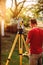 surveyor caucasian engineer working with total station theodolite at landscaping project
