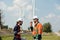 Surveyor and engineer Examine the efficiency of gigantic wind turbines that transform wind energy into electrical energy that is