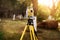 Surveyor engineering equipment with theodolite and total station in a garden