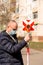 Surveyor holds a geodetic pole in a protective mask