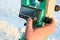 Surveyor`s finger presses the button on the total station