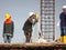 Surveyor with survey equipment at the construction site.