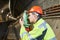 Surveyor with theodolite level at underground railway tunnel construction work