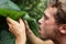 Survival - man drinking from leaf in jungle