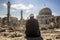Survivor& x27;s Prayer: Elderly Man at Mosque Ruins, Sunny Day